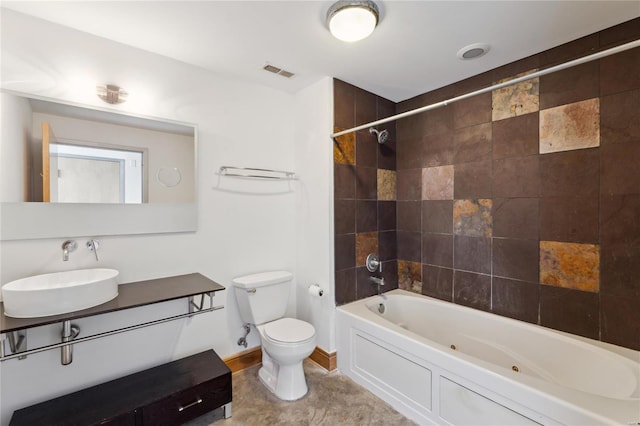 bathroom with baseboards, visible vents, toilet, vanity, and washtub / shower combination