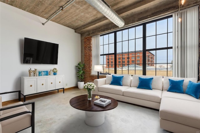 living room with concrete floors and baseboards