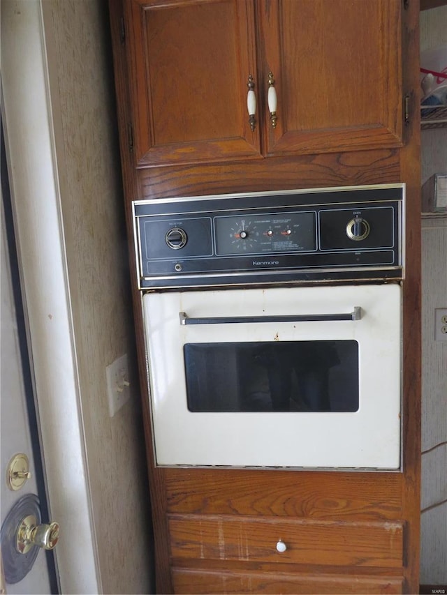 interior details featuring brown cabinets and oven