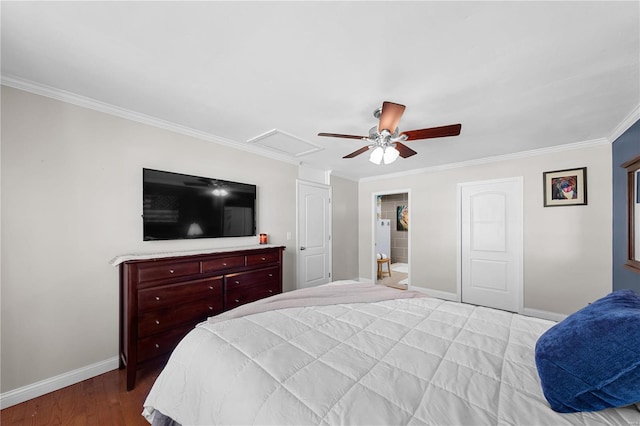 bedroom featuring ceiling fan, wood finished floors, baseboards, attic access, and crown molding