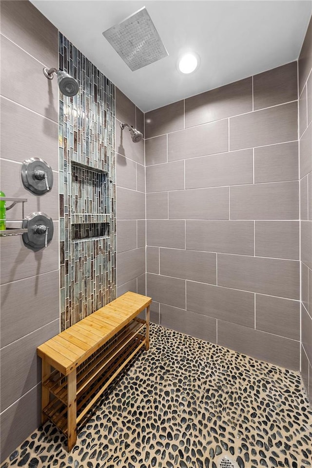 full bath with a tile shower