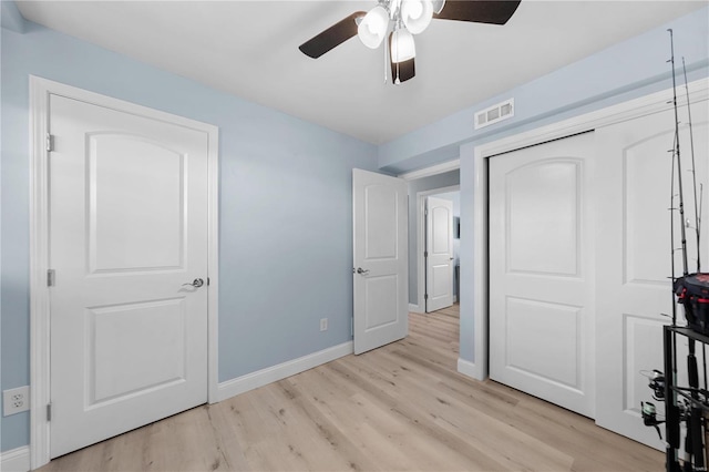 unfurnished bedroom featuring a closet, visible vents, light wood-style flooring, and baseboards