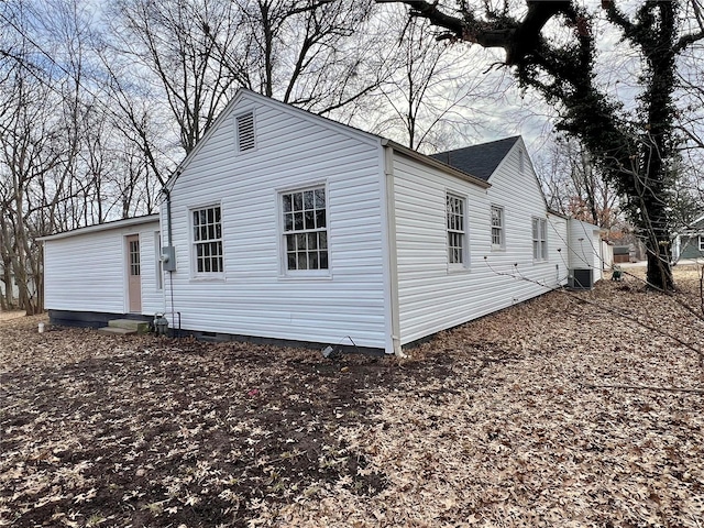 view of property exterior featuring crawl space, central air condition unit, and entry steps