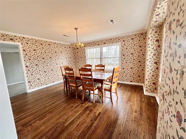 dining space with wallpapered walls, crown molding, baseboards, dark wood-style floors, and a notable chandelier