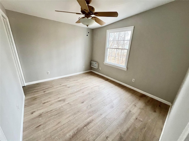 unfurnished bedroom with a ceiling fan, wood finished floors, and baseboards