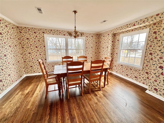 dining room featuring visible vents, wallpapered walls, crown molding, and dark wood-style flooring