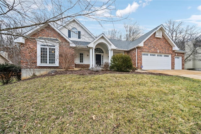 traditional-style house featuring driveway, a front yard, a garage, and brick siding