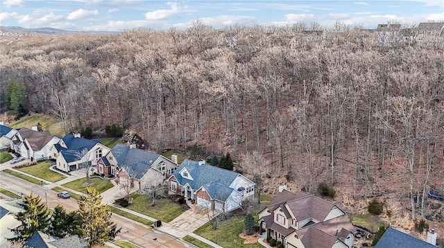 aerial view featuring a forest view and a residential view