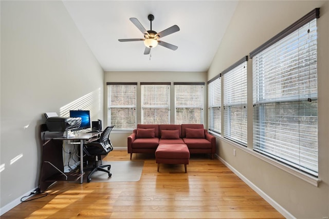 office space featuring lofted ceiling, ceiling fan, hardwood / wood-style floors, and baseboards