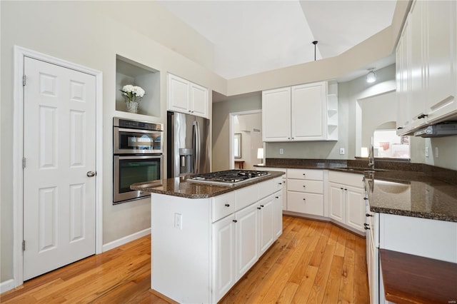 kitchen with open shelves, appliances with stainless steel finishes, white cabinetry, and a center island