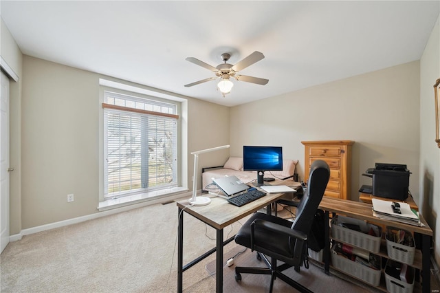 office space with ceiling fan, carpet floors, and baseboards