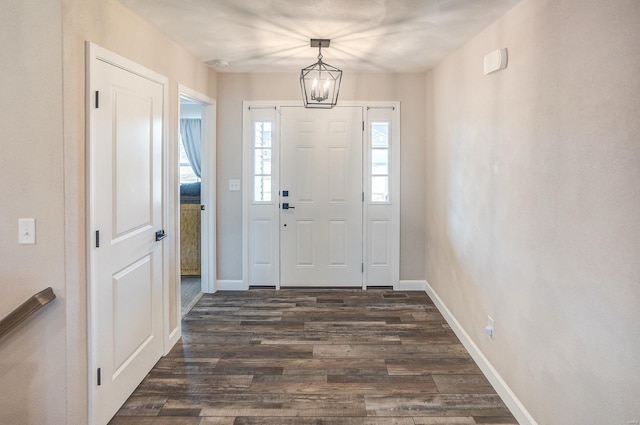 foyer with dark wood-type flooring and baseboards