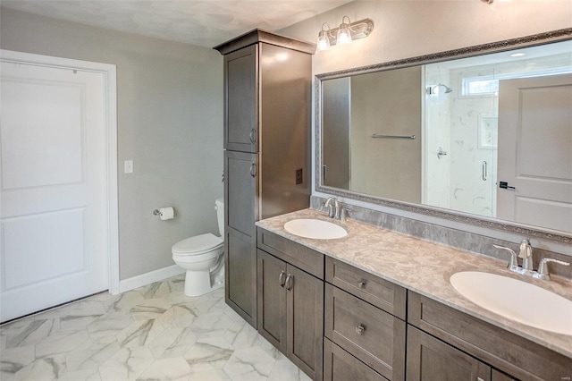 full bathroom with toilet, marble finish floor, baseboards, and a sink