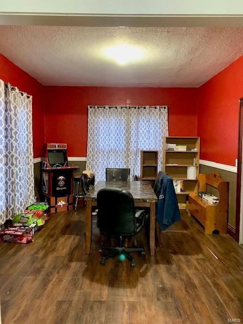 home office featuring a textured ceiling and wood finished floors