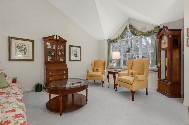 sitting room with lofted ceiling and carpet