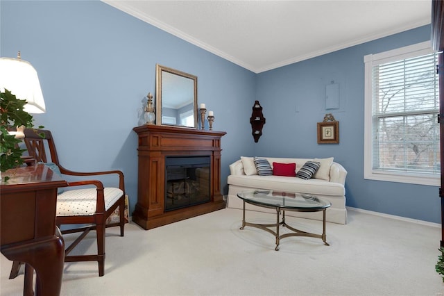 living area with light carpet, a glass covered fireplace, crown molding, and baseboards