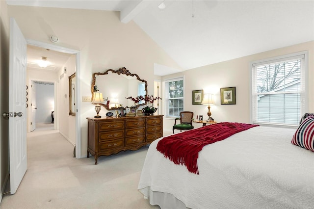 bedroom with multiple windows, beam ceiling, light colored carpet, and high vaulted ceiling