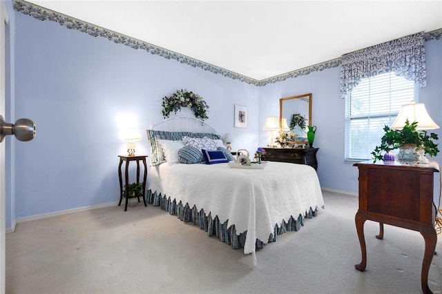 carpeted bedroom featuring baseboards