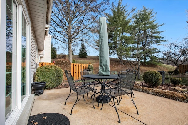 view of patio with outdoor dining space and fence