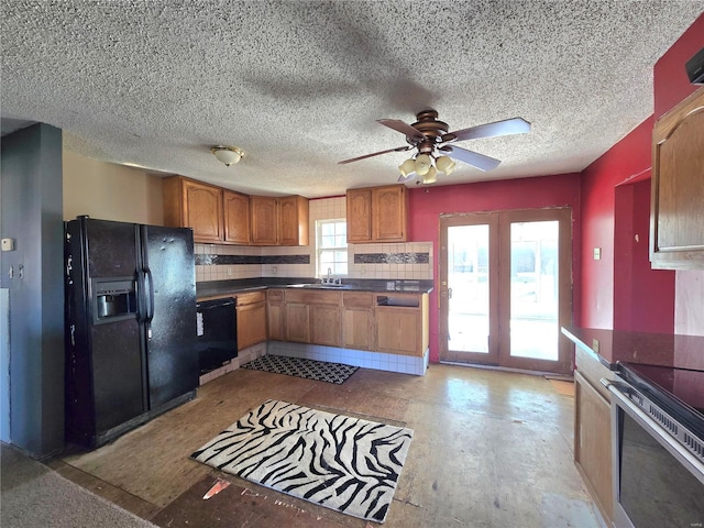 kitchen with ceiling fan, a sink, brown cabinets, black appliances, and dark countertops