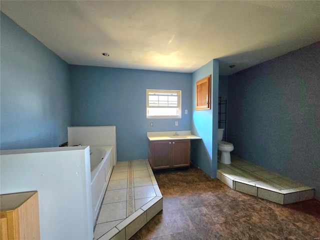 full bathroom featuring toilet, a garden tub, and vanity