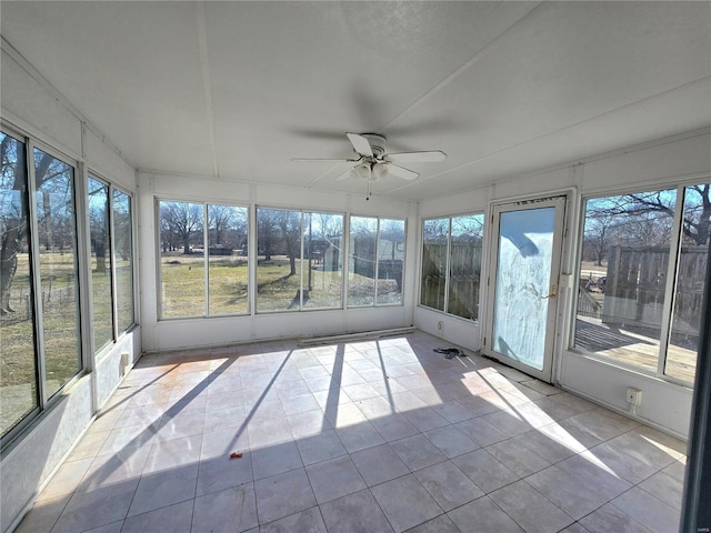 unfurnished sunroom featuring ceiling fan