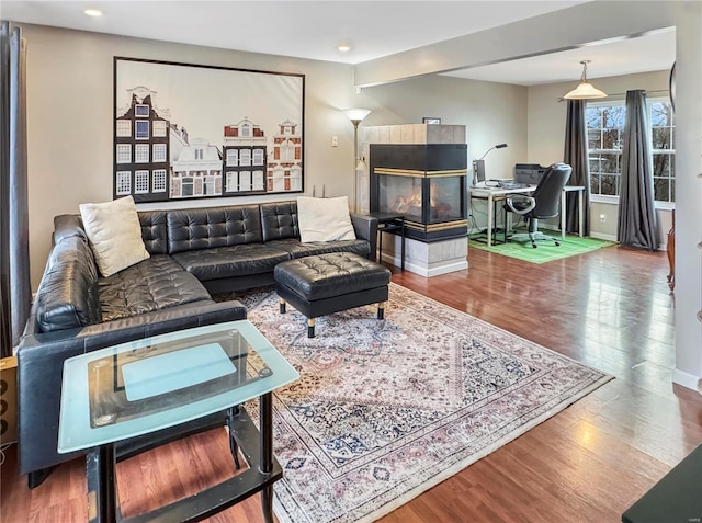 living area featuring baseboards and wood finished floors