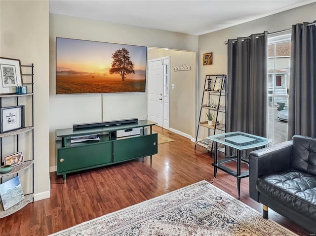 living room featuring baseboards and wood finished floors