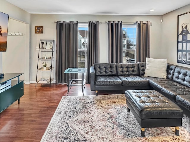 living area with wood finished floors and baseboards