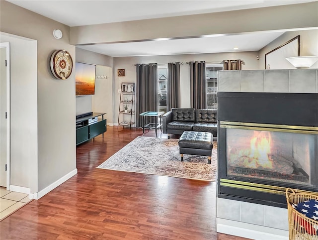 living room with baseboards and wood finished floors