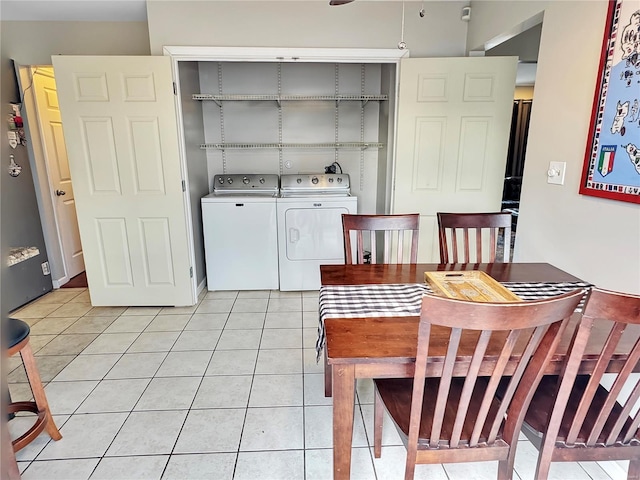 dining space featuring washer and dryer and light tile patterned floors