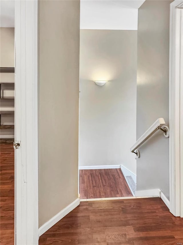 staircase with baseboards and wood finished floors