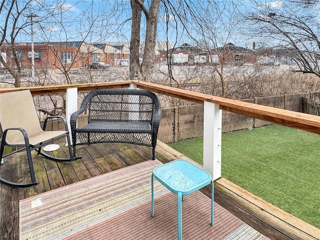 wooden deck featuring a yard, fence, and a residential view