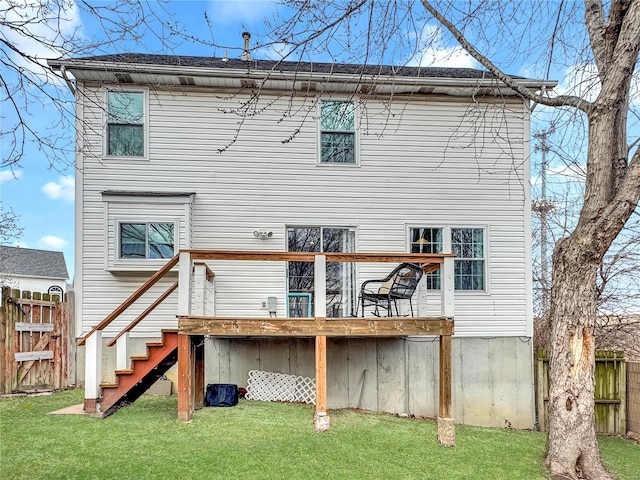 back of house with a yard, fence, a wooden deck, and stairs