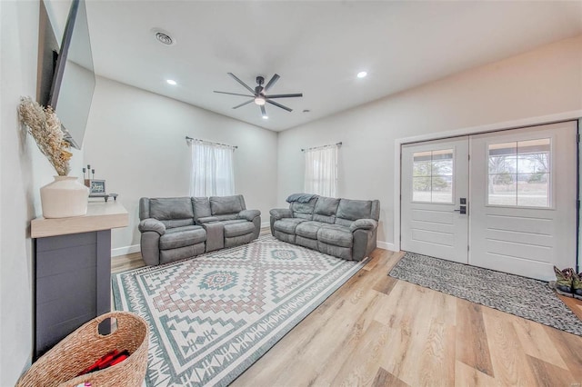 living room featuring french doors, recessed lighting, visible vents, light wood-style floors, and baseboards