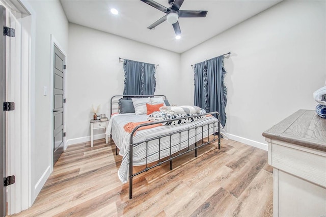 bedroom featuring a ceiling fan, baseboards, wood finished floors, and recessed lighting