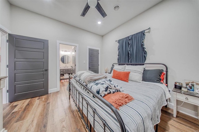 bedroom featuring baseboards, visible vents, a ceiling fan, connected bathroom, and wood finished floors