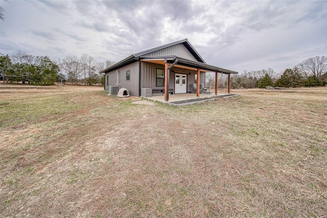 view of front facade featuring a front yard, french doors, and a patio