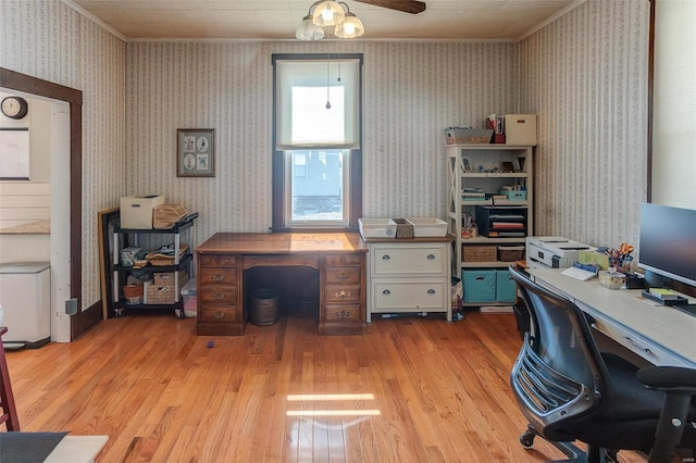 office area with crown molding, light wood-style floors, and wallpapered walls