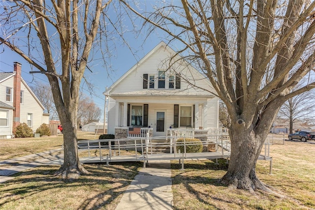 view of front facade with covered porch and a front lawn