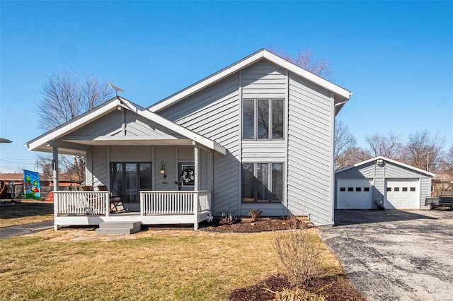 view of front of property featuring a detached garage, a front lawn, and an outdoor structure