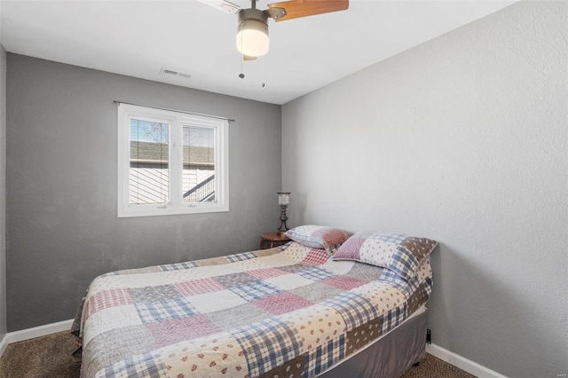 bedroom featuring baseboards, visible vents, ceiling fan, and carpet flooring