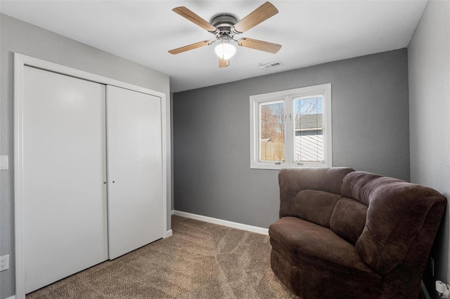 sitting room featuring carpet, visible vents, ceiling fan, and baseboards