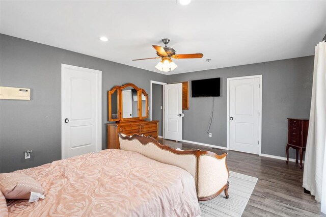 bedroom with a ceiling fan, recessed lighting, baseboards, and wood finished floors