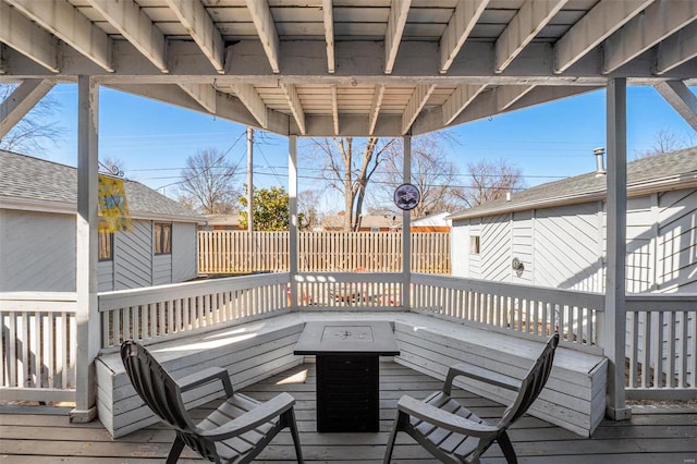 wooden terrace featuring fence