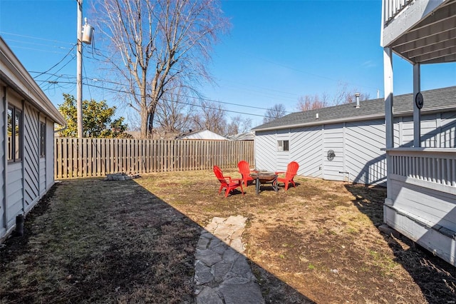 view of yard featuring a fire pit and a fenced backyard