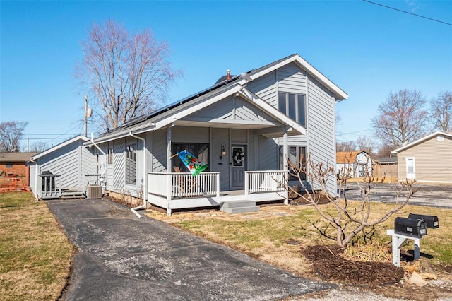 bungalow-style home featuring covered porch and solar panels