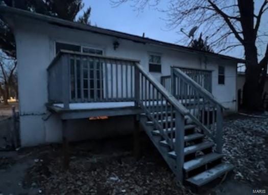 back of property with stairs and a deck