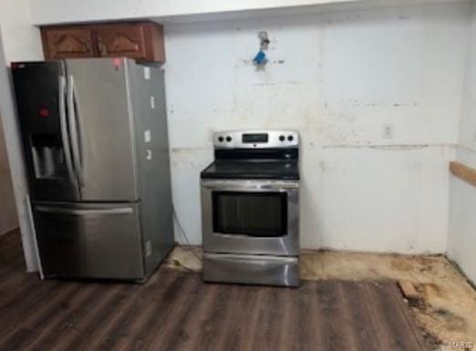 kitchen featuring appliances with stainless steel finishes and dark wood-style flooring