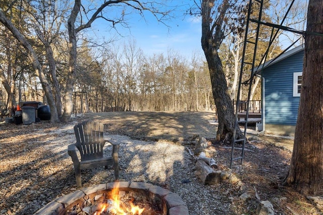 view of yard with an outdoor fire pit